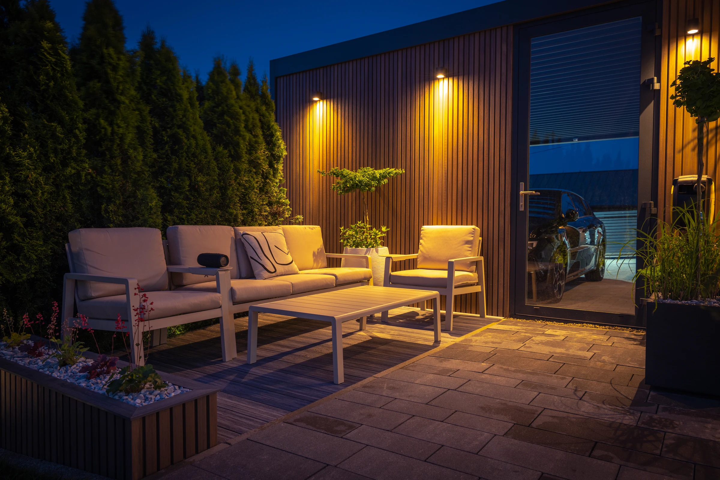 Outdoor patio with warm wall and garden lighting